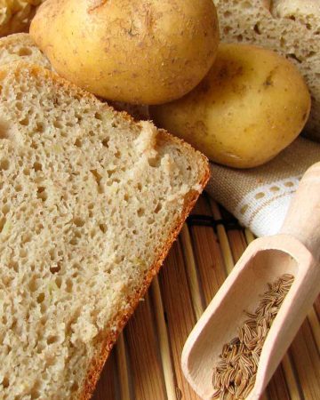 A couple of potatoes and some bread on a table