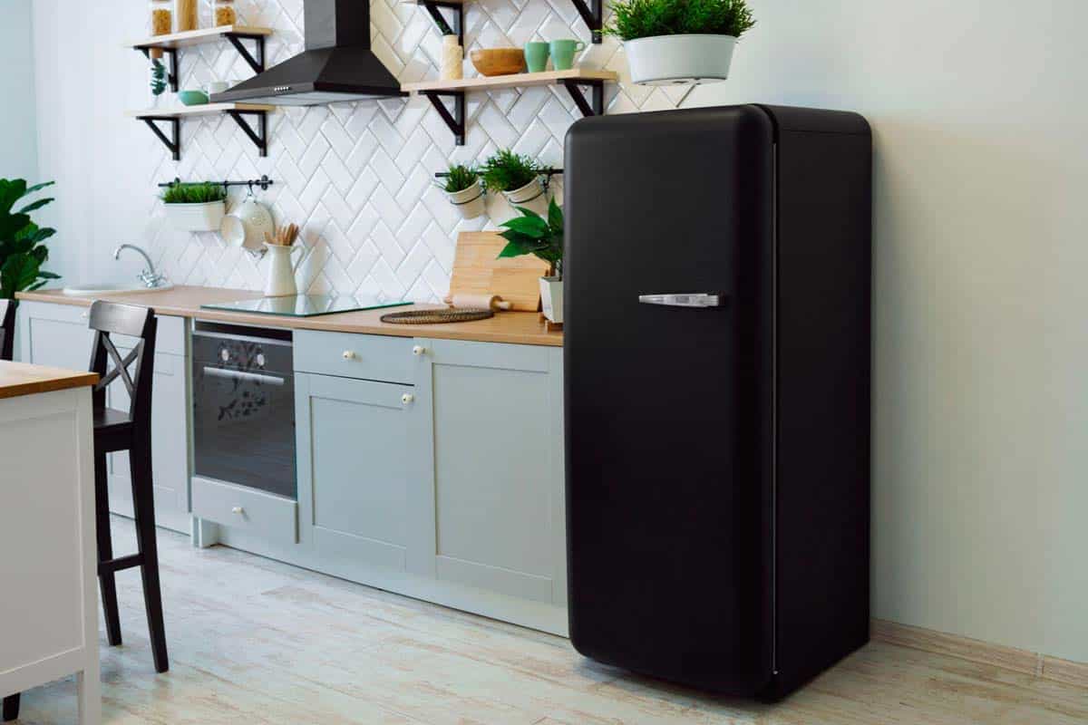 A black refrigerator in a kitchen