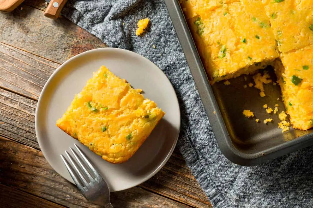 Cornbread on a plate on a wooden table.